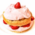 Image of Strawberry Shortcake Keto Low Carb with pink frosting and strawberries on a white plate.