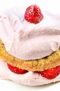 Image of Strawberry Shortcake Keto Low Carb with pink frosting and strawberries on a white plate.