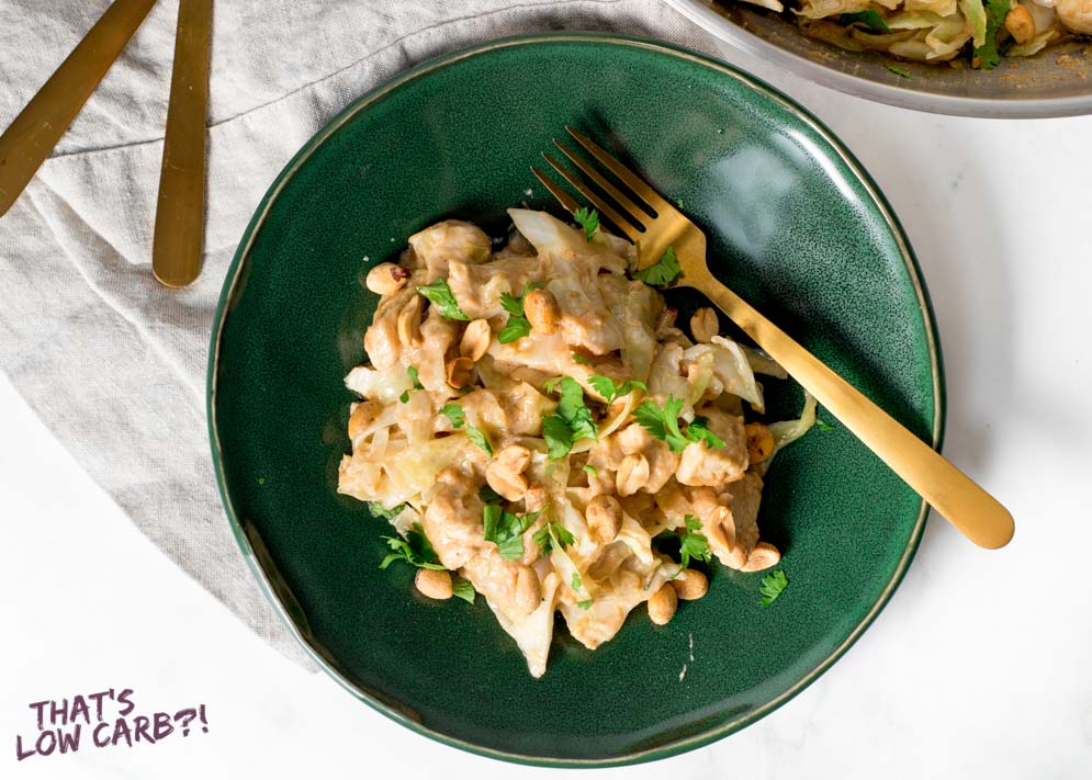 Overhead shot of Keto Thai Chicken portion on a green plate with a bronze fork laying beside.