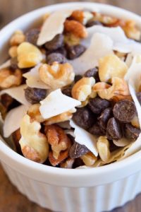 Low Carb Party Mix with assortment of nuts and chocolate in a white bowl.