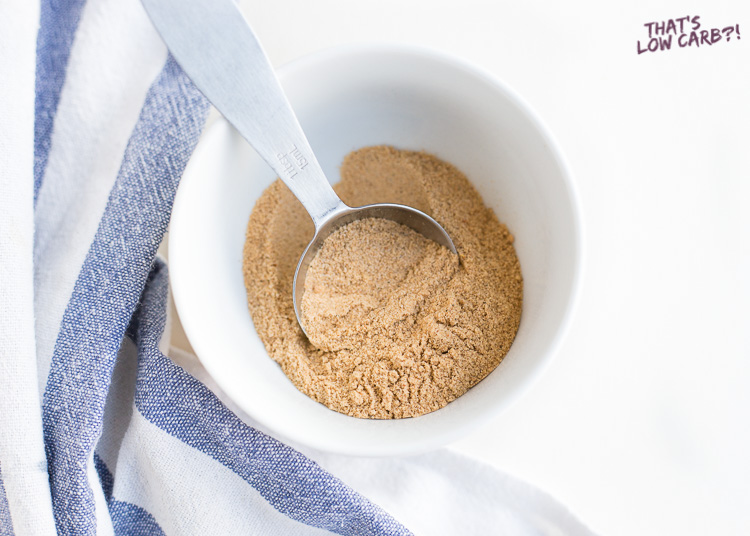 Overhead shot of low carb keto fajita seasoning in a small white bowl with a tablespoon sticking out.