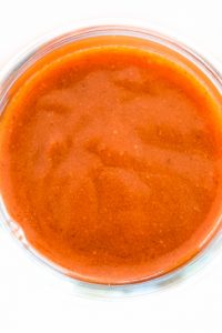 Overhead shot of Keto Enchilada Sauce in a glass jar.