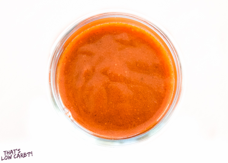Overhead shot of Keto Enchilada Sauce in a glass jar.