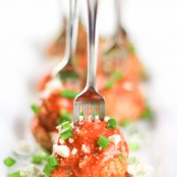 Image of Low Carb Keto Buffalo Meatballs lined up with green onion sprinkled over top.