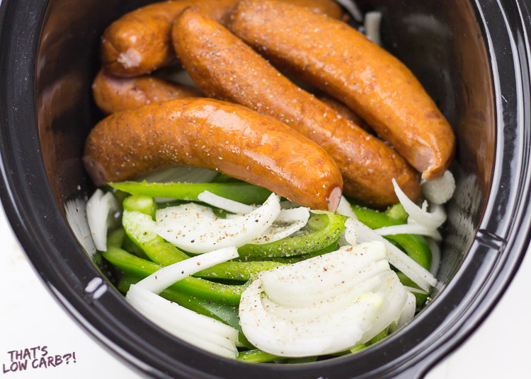 Image of Slow Cooker Low Carb Sausage and Peppers ingredients in a black crock pot.