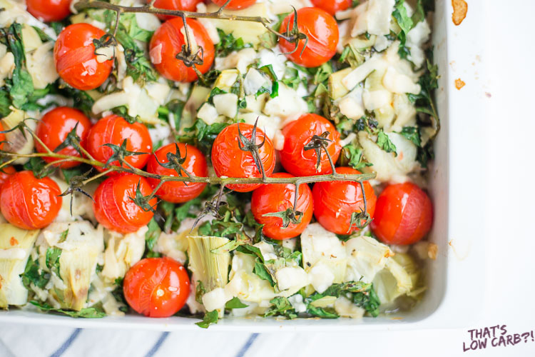Image of Low Carb Artichoke Cheese Chicken Dinner in a casserole dish with spinach, goat cheese, and roasted tomatoes..