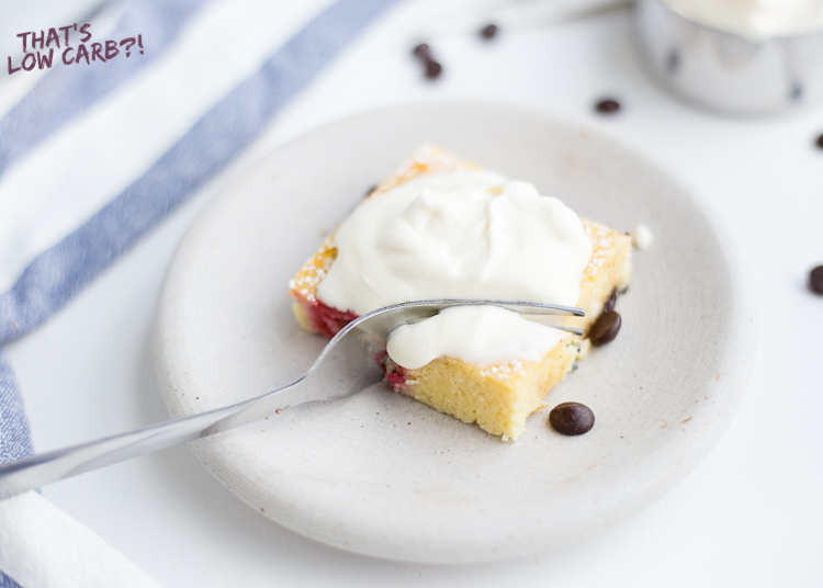 Image of Low Carb Raspberry Chocolate Sponge Cake square with whipped cream on top.