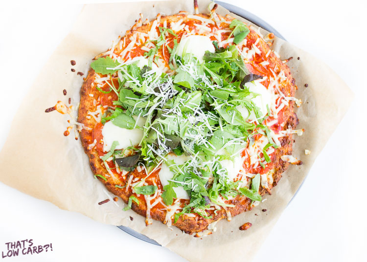 Overhead shot of Easy Keto Pizza Dough Crust pizza with spinach and mozzarella on top.