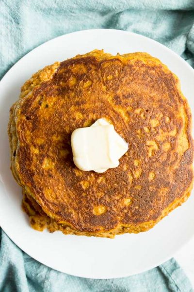 Overhead shot of low carb pumpkin pancakes on a white plate