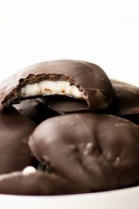Image of Sugar Free, Low Carb, keto, Peppermint Patties in a white bowl with top one missing a bite.