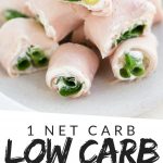 PINTEREST IMAGE with words "1 net carb low carb ham roll ups" with image of Low Carb Ham Roll Ups Pinwheels on a white plate filled with cream cheese and green onion.