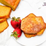 Image of Keto French Toast with strawberries on a white plate with slices laid out beside.
