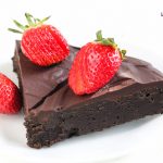 Image of Keto Flourless Chocolate Cake slices with strawberries on top.