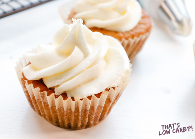 Image of two Vanilla Keto Cupcakes with white frosting side by side.