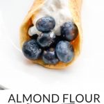 PINTEREST IMAGE with words "almond flour keto crepes" with image of almond flour keto crepes filled with blueberries and whipped cream.