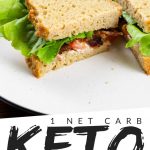 PINTEREST IMAGE with words " 1 net carb keto bread" with image of keto bread sandwich sliced in half on a white plate with bacon and lettuce showing.