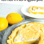 PINTEREST IMAGE with words "5 net carb keto lemon meringue pie" with the pie missing one piece in a glass pie pan on a grey towel, with 2 lemons behind and the missing piece in the upper right hand corner on a white plate.
