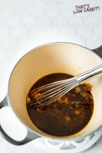 mixing barbecue sauce ingredients together in saucepan with whisk