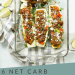 Zucchini Sliced in half with meat and cheese in a casserole dish