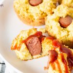 corn dog muffin sliced in half with ketchup