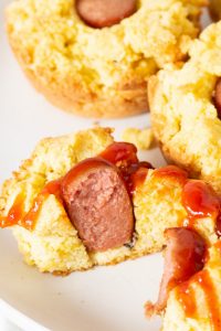 corn dog muffin sliced in half with ketchup