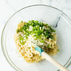 Bay Biscuit ingredients in a large glass bowl with a spatula sticking out