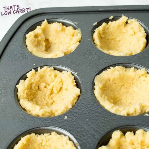 dough spread into cup shape in a muffin tin