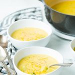Two bowls with broccoli cheddar soup